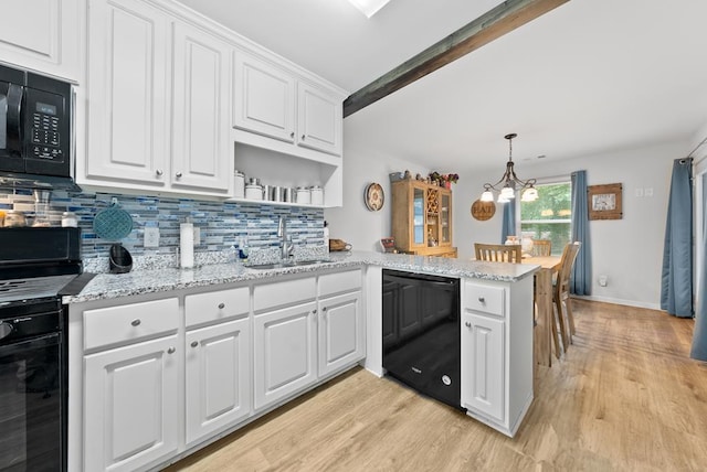 5608 Grove Ave, Columbus, GA 31904 - kitchen featuring black appliances, light wood finished floors, white cabinetry, a peninsula, and tasteful backsplash