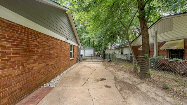 5608 Grove Ave, Columbus, GA 31904 - view of side of property featuring brick siding, a garage, and a gate