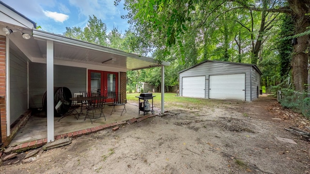 5608 Grove Ave, Columbus, GA 31904 - view of patio with grilling area, an outbuilding, a detached garage, and driveway