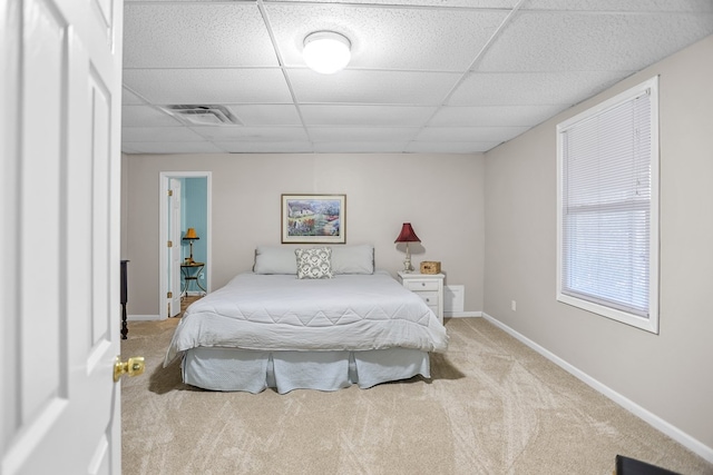 carpeted bedroom with a paneled ceiling