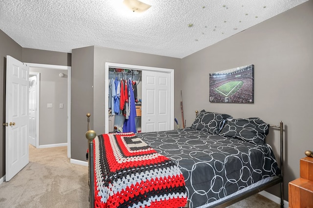 bedroom with a closet, carpet, and a textured ceiling