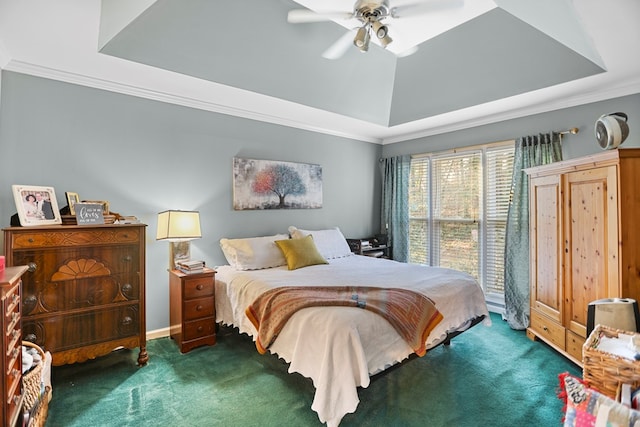 carpeted bedroom with ceiling fan, crown molding, and a tray ceiling