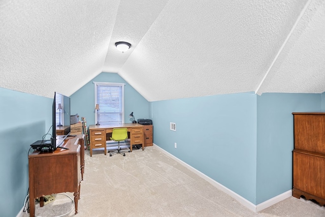 carpeted office featuring a textured ceiling and lofted ceiling