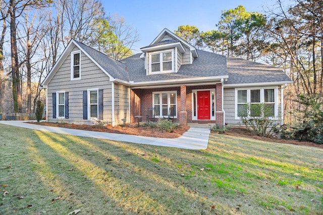 cape cod home with a front lawn