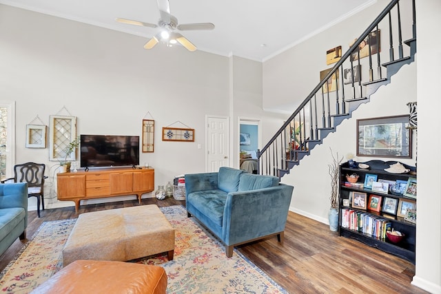 living room with ceiling fan, ornamental molding, and hardwood / wood-style flooring