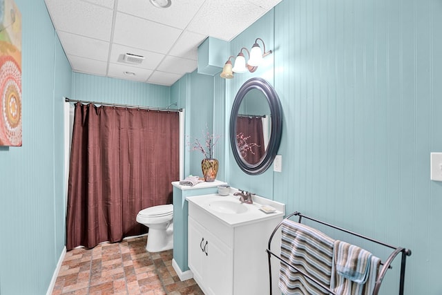 bathroom featuring vanity, toilet, and a paneled ceiling