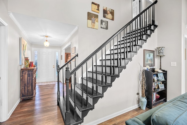 stairway featuring hardwood / wood-style flooring and ornamental molding