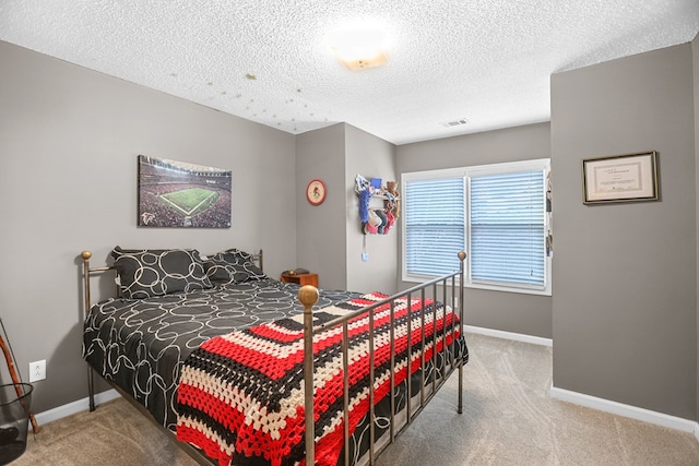 bedroom featuring carpet and a textured ceiling