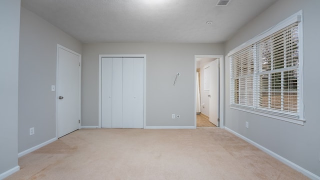 6847 Fawndale Dr, Columbus, GA 31904 - unfurnished bedroom with carpet flooring, a textured ceiling, a closet, and ensuite bath