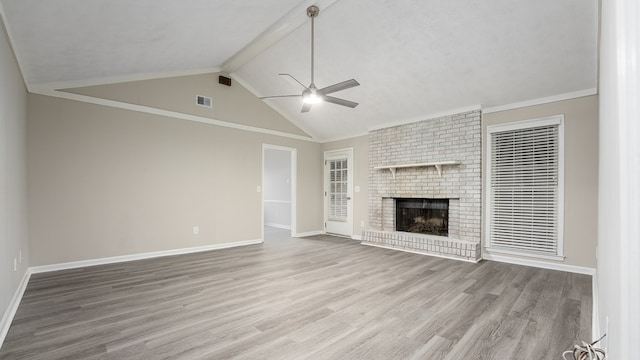 6847 Fawndale Dr, Columbus, GA 31904 - unfurnished living room featuring a ceiling fan, wood finished floors, a brick fireplace, beam ceiling, and high vaulted ceiling