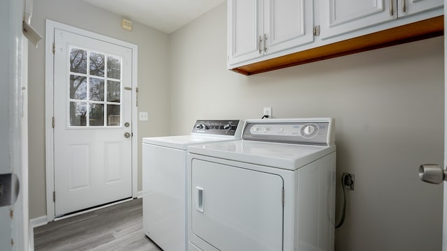 6847 Fawndale Dr, Columbus, GA 31904 - laundry area with cabinet space, light wood-type flooring, and washer and clothes dryer