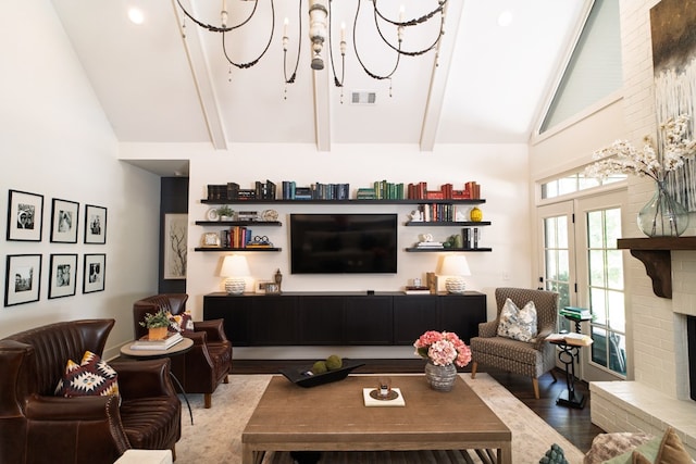719 Harris Rd, Cataula, GA 31804 - living room with high vaulted ceiling, wood finished floors, a chandelier, beam ceiling, and a brick fireplace