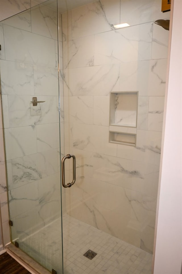 full bath featuring a marble finish shower