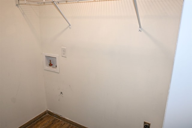 laundry area with dark wood finished floors, hookup for a washing machine, electric dryer hookup, laundry area, and baseboards