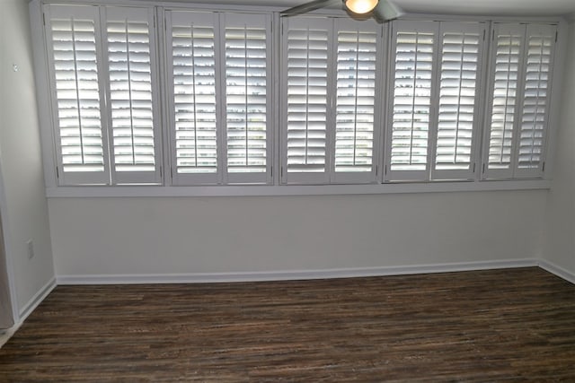 unfurnished room featuring baseboards and wood finished floors