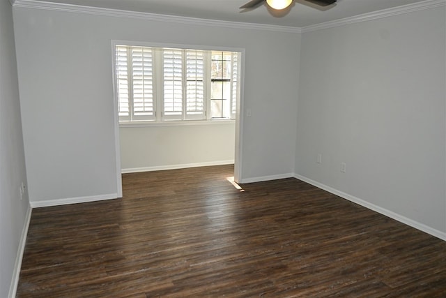 spare room featuring a ceiling fan, dark wood-style flooring, crown molding, and baseboards