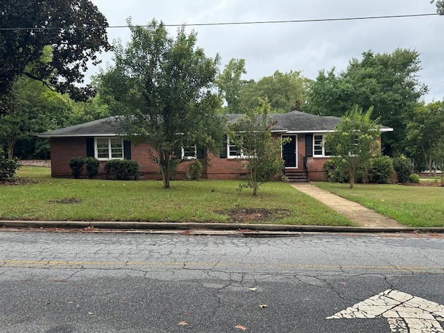 ranch-style home with a front lawn