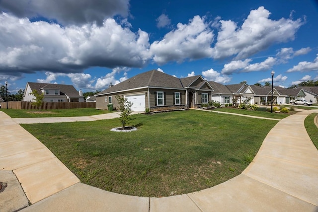 view of front of property with a front yard and a garage