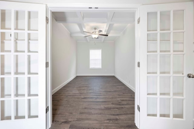 spare room featuring coffered ceiling, dark wood-type flooring, ceiling fan, and beam ceiling