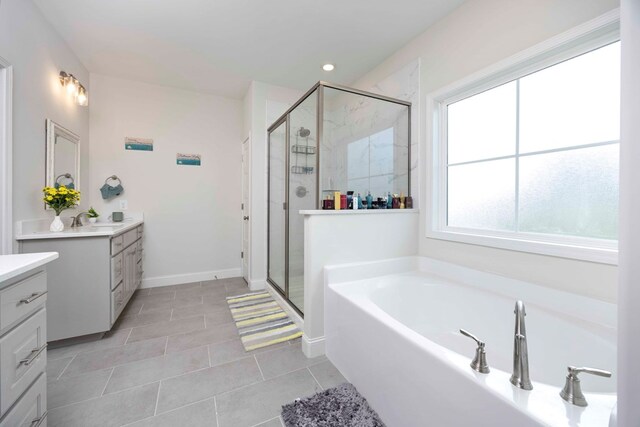 bathroom featuring tile patterned flooring, a shower with door, and vanity