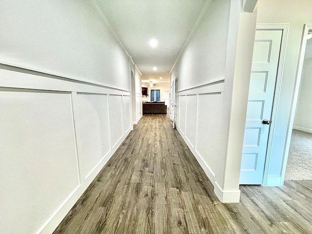 corridor featuring hardwood / wood-style floors and ornamental molding