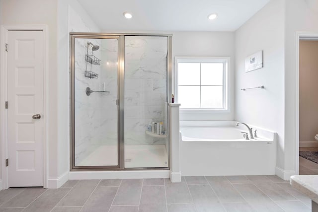 bathroom featuring separate shower and tub and tile patterned floors