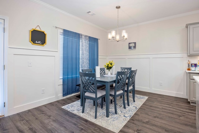 dining room featuring a notable chandelier, ornamental molding, and dark hardwood / wood-style flooring