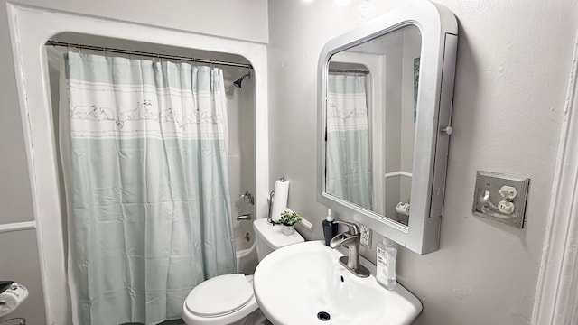 full bathroom with sink, shower / bath combination with curtain, and toilet