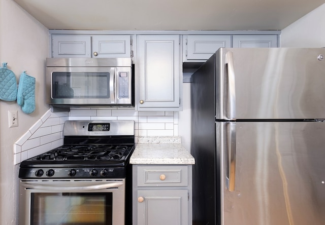 kitchen featuring white cabinetry, tasteful backsplash, and appliances with stainless steel finishes