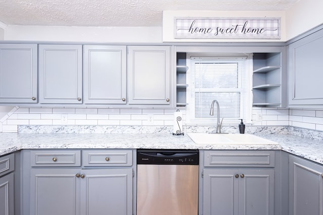 kitchen featuring tasteful backsplash, dishwasher, sink, and gray cabinetry