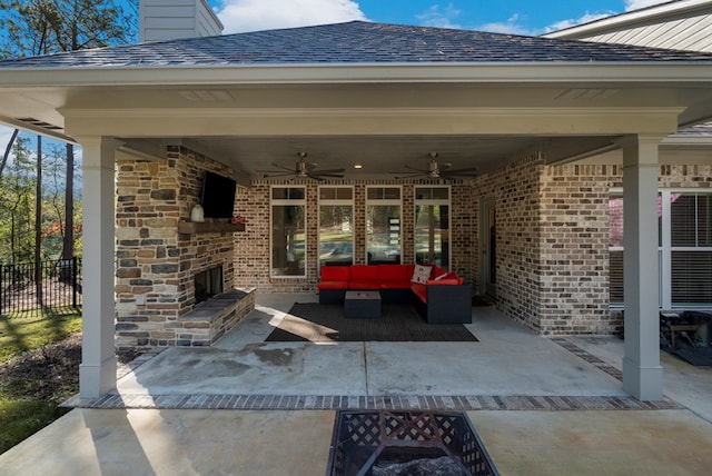 view of patio with an outdoor living space with a fireplace and ceiling fan