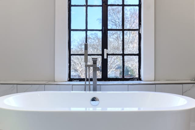 bathroom featuring a tub to relax in