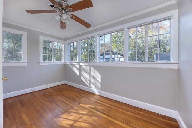 unfurnished sunroom with ceiling fan