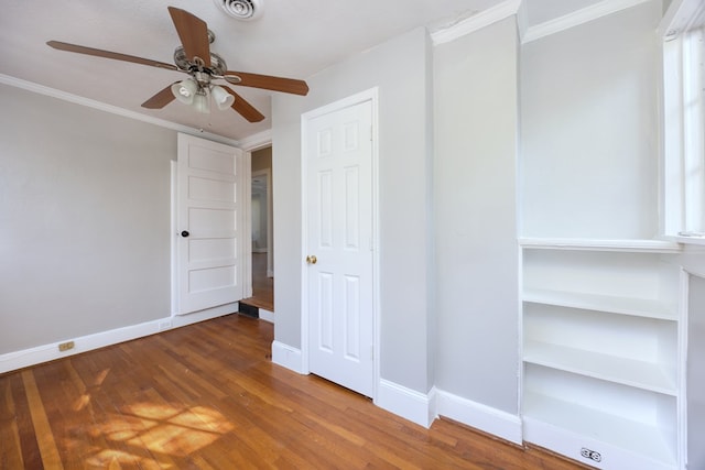 unfurnished bedroom with crown molding and hardwood / wood-style floors