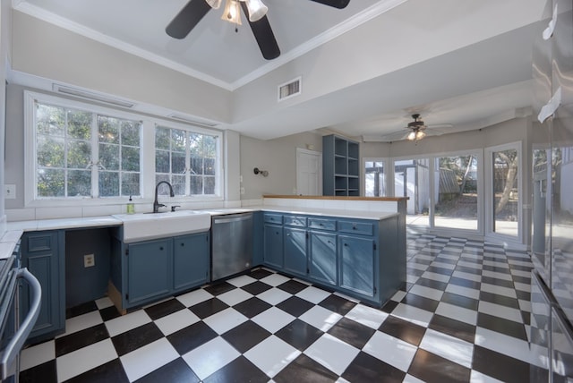 kitchen with blue cabinetry, plenty of natural light, dishwasher, and sink