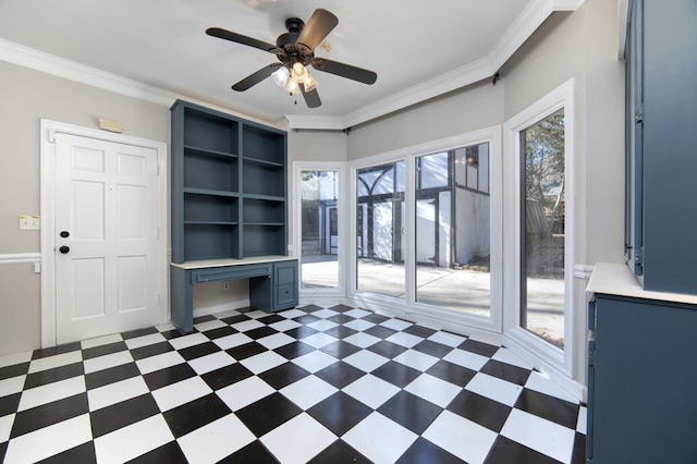 interior space featuring ornamental molding, built in desk, and ceiling fan