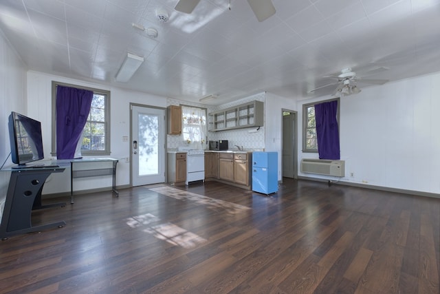 kitchen with dark hardwood / wood-style flooring, ceiling fan, a wall unit AC, and dishwasher