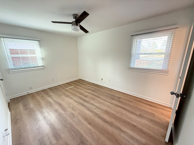 unfurnished bedroom featuring a ceiling fan, baseboards, and wood finished floors