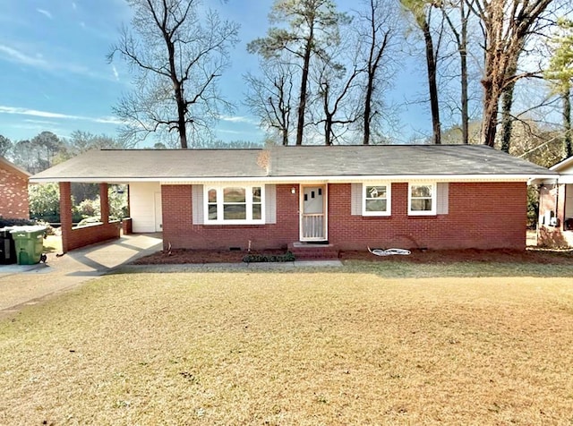 ranch-style house with driveway, brick siding, and a front lawn