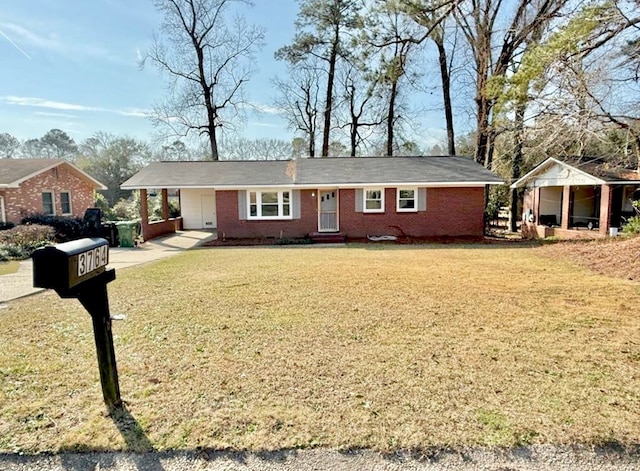 single story home featuring driveway, brick siding, a carport, and a front yard