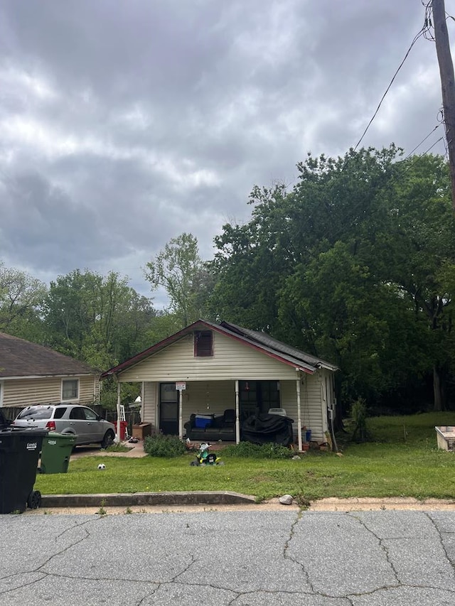 view of front of home with a carport and a front lawn