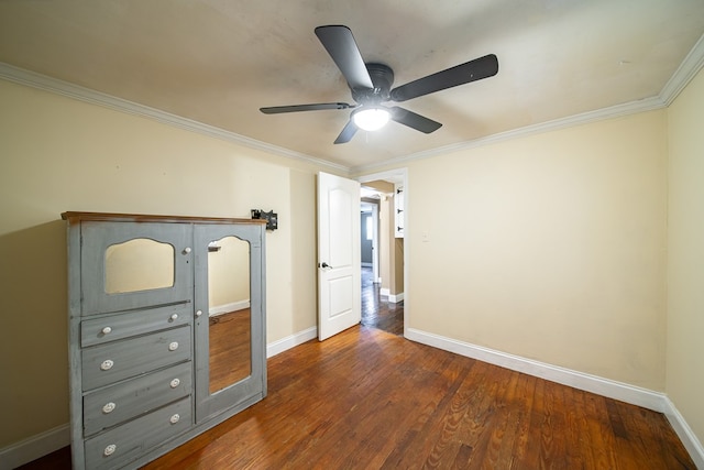 unfurnished bedroom featuring ceiling fan, crown molding, and dark wood-type flooring