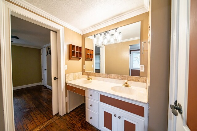 bathroom featuring a textured ceiling, vanity, hardwood / wood-style flooring, and crown molding