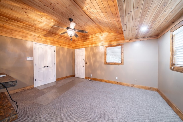 carpeted empty room featuring ceiling fan, lofted ceiling, and wood ceiling