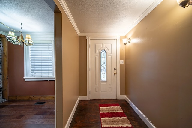 entryway with a textured ceiling, dark hardwood / wood-style flooring, and crown molding