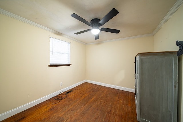 spare room featuring dark hardwood / wood-style floors, ceiling fan, and ornamental molding