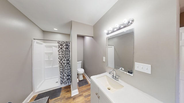 bathroom featuring vanity, toilet, a shower with shower curtain, and hardwood / wood-style flooring