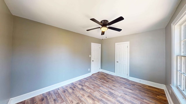 unfurnished room with ceiling fan and wood-type flooring