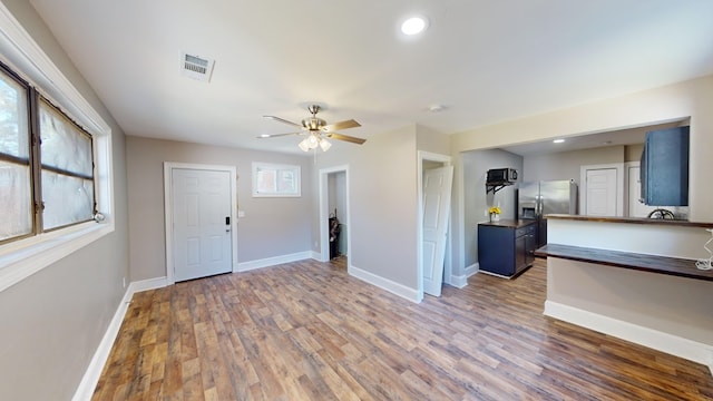 interior space featuring ceiling fan and dark hardwood / wood-style floors