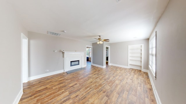 unfurnished living room with light hardwood / wood-style flooring and ceiling fan